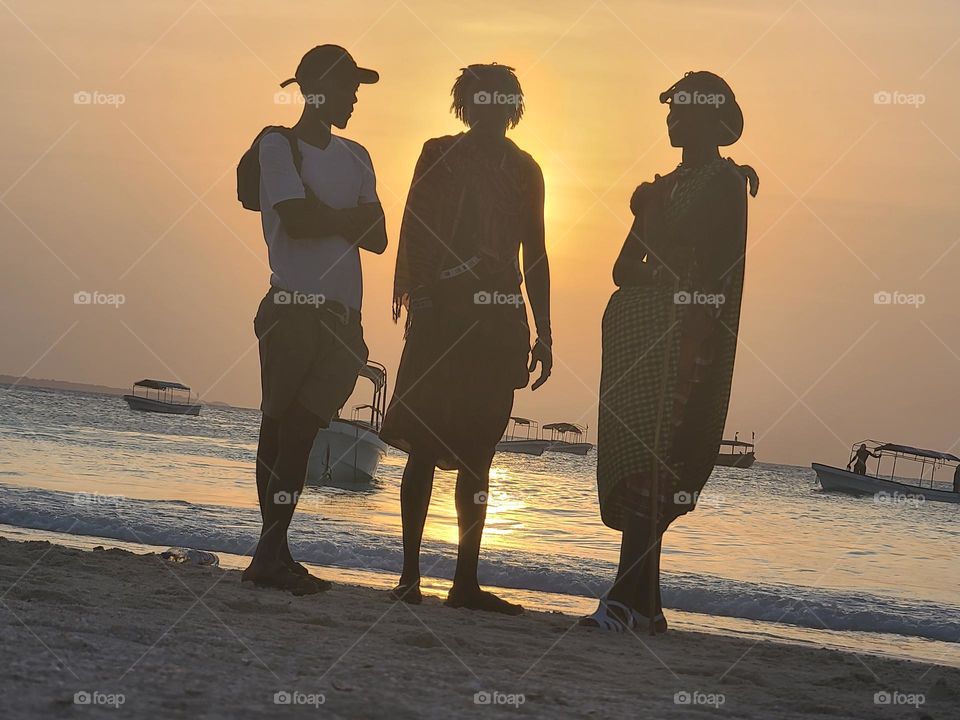 Silhouettes of people on the beach in Zanzibar
