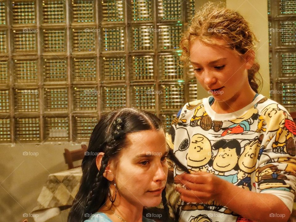 Young Girl Braiding Older Girl's Hair