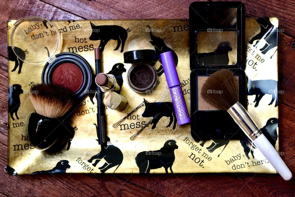  Hot Mess,Makeup tray with with various items on it on a wooden backdrop 