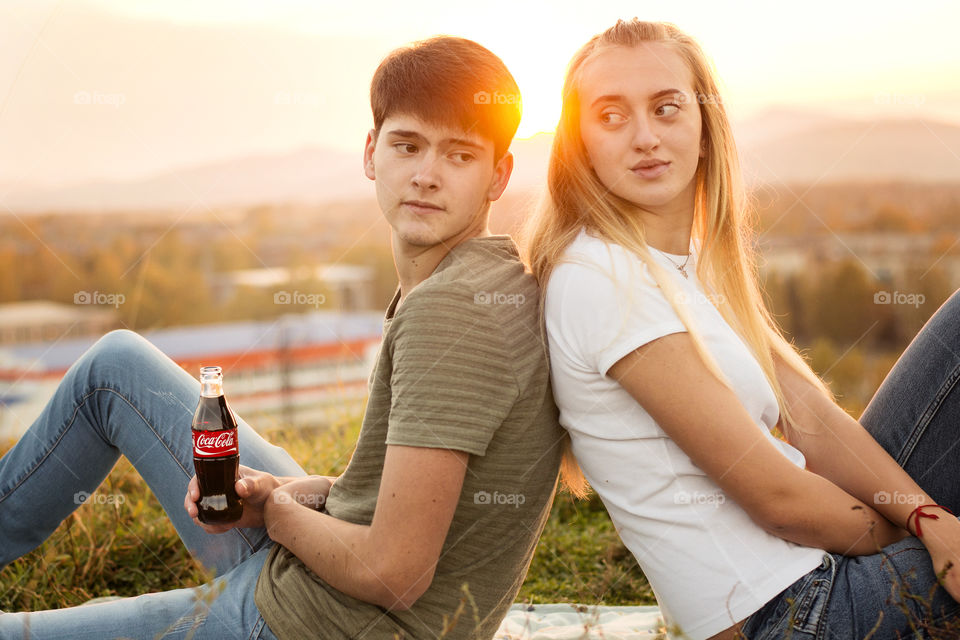 Portrait of couple sitting back to back