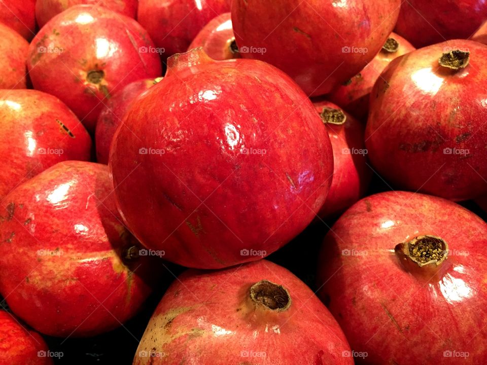 Pomegranates. A selection of red glossy pomegranates ready for purchase.