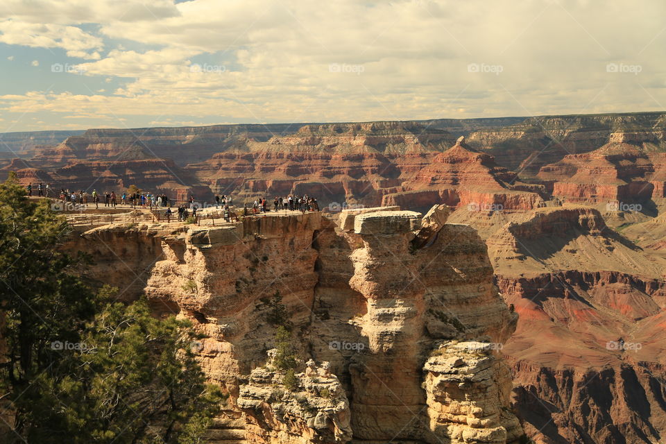 Group of tourists enjoying view of grand canyon