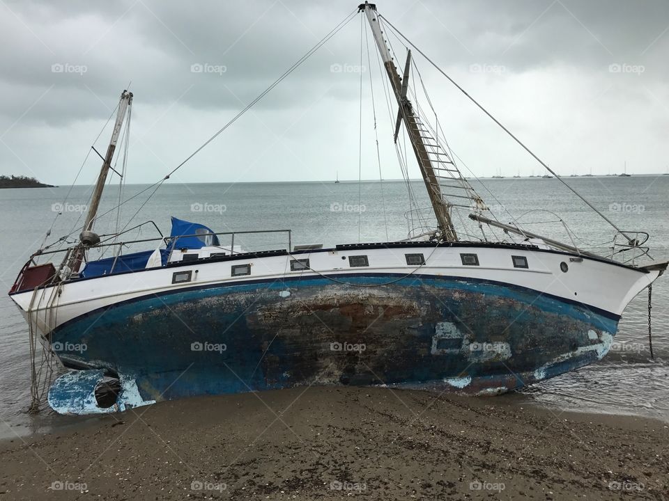 Capsized sailboat in aftermath of Cyclone Debbie I. Queensland south Australia editorial 