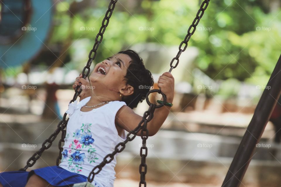 Happy and joyful Indian kid playing in a park