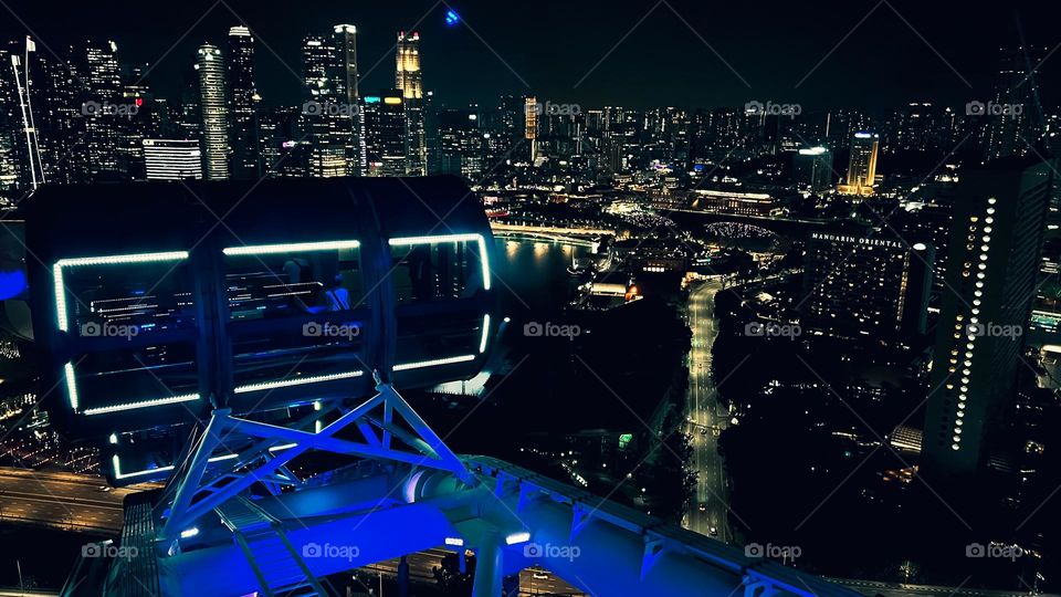 View of Singapore city at night from the deck of the Singapore Flyer.