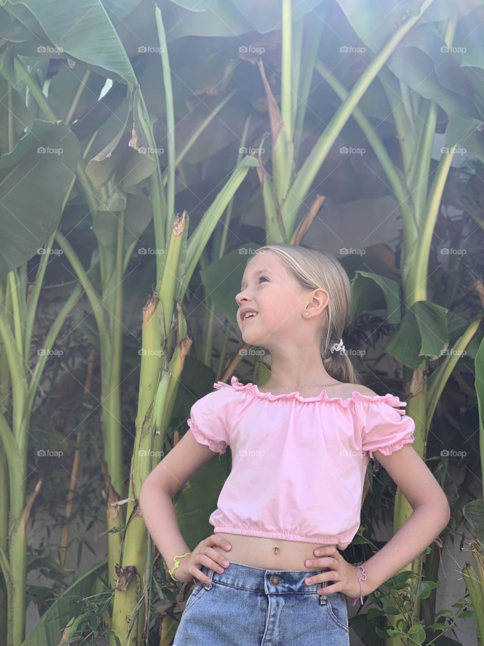 Stylish girl with banana plant