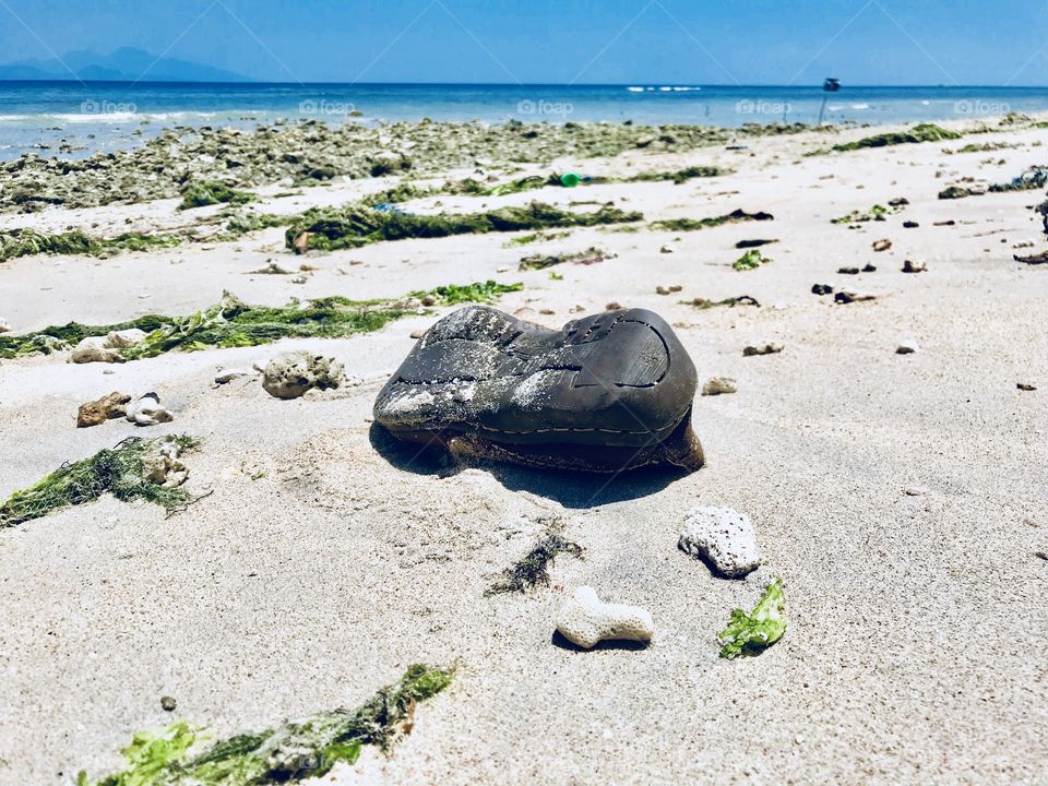 Abandoned shoe on a beach 