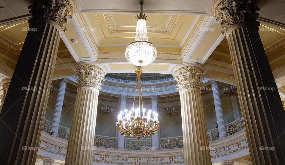 Classical architecture style. Columns. Chandeliers. Ceiling.