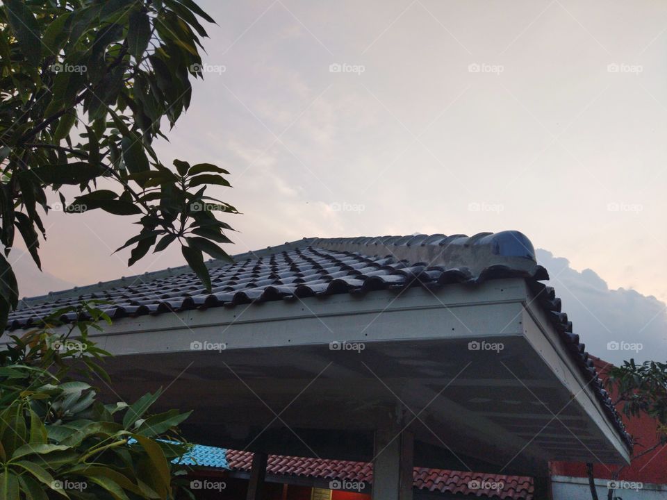 Very nice house tile architecture with clouds above it