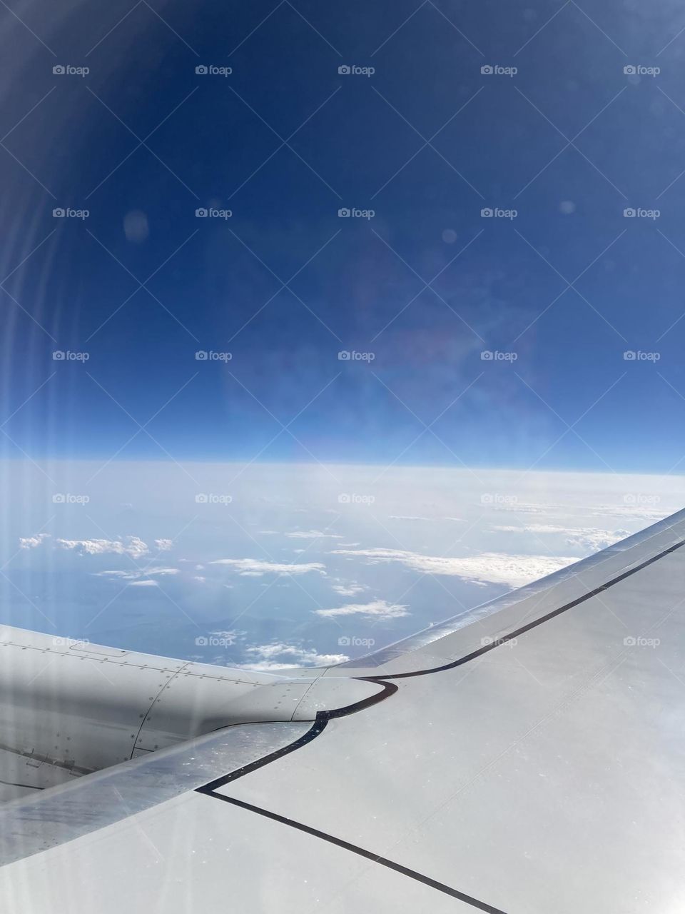 Airplane window seat view. Landscape from the top. With my head in the clouds. Beautiful view from the sky. 
