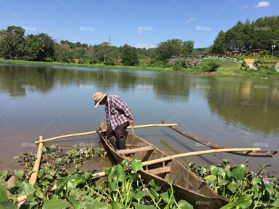 A clear water river with a humble boat 