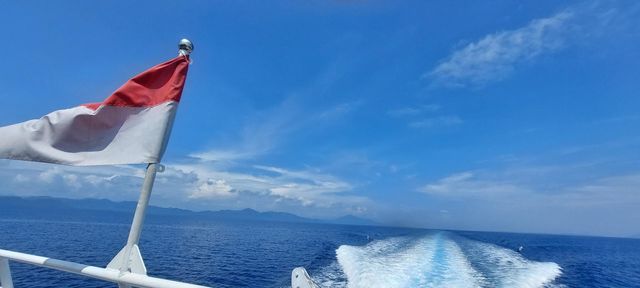 flag on a boat with blue natural sea views in eastern Indonesia