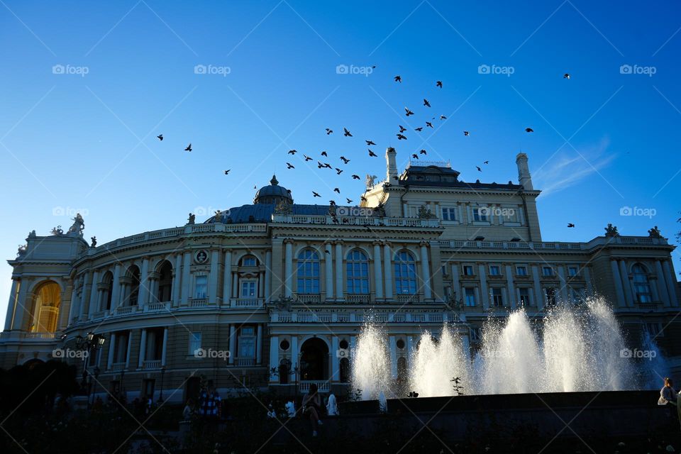 Beautiful building of Opera House in Odesa Ukraine, birds, people, fountain