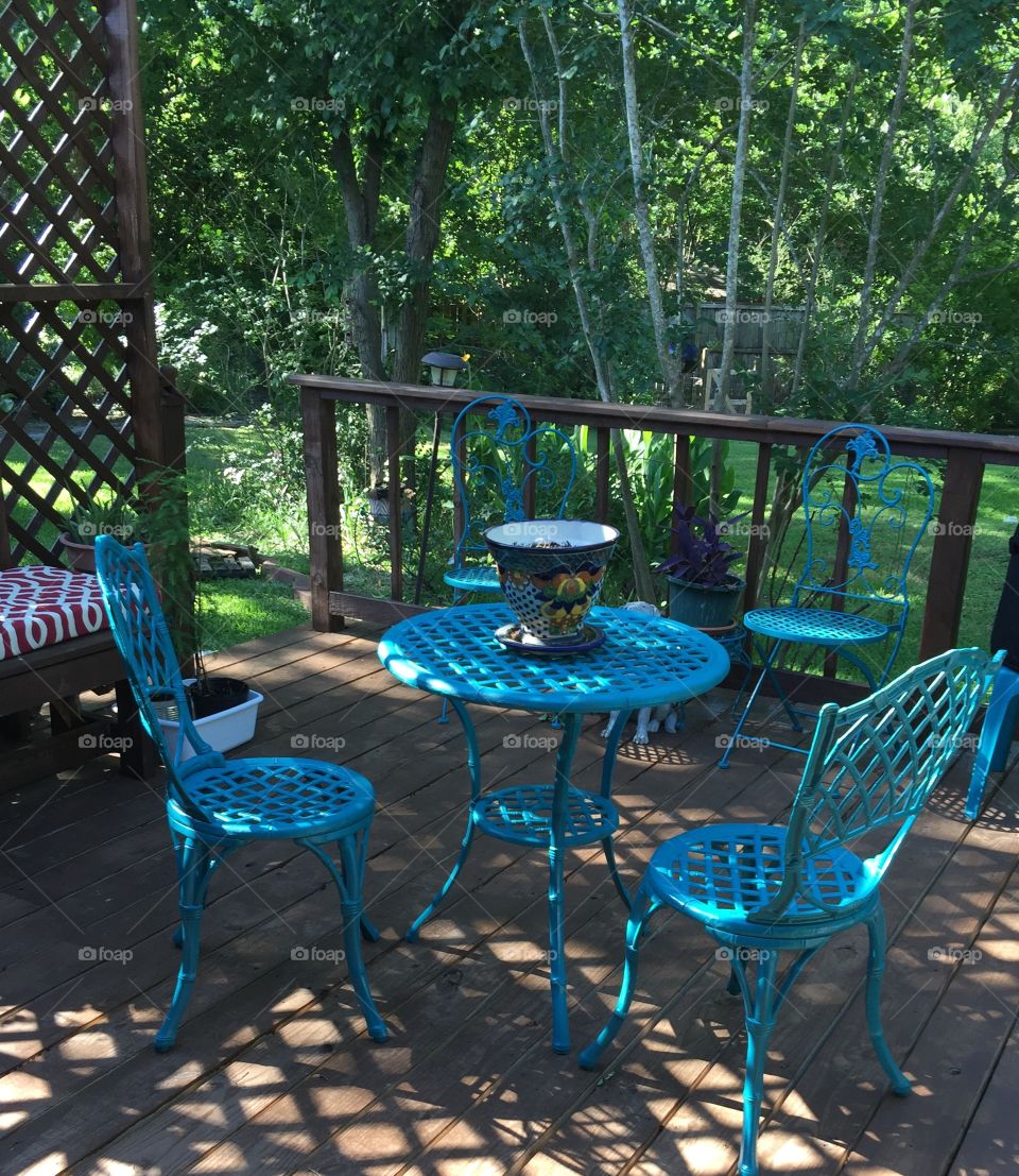Shady deck with blue patio furniture