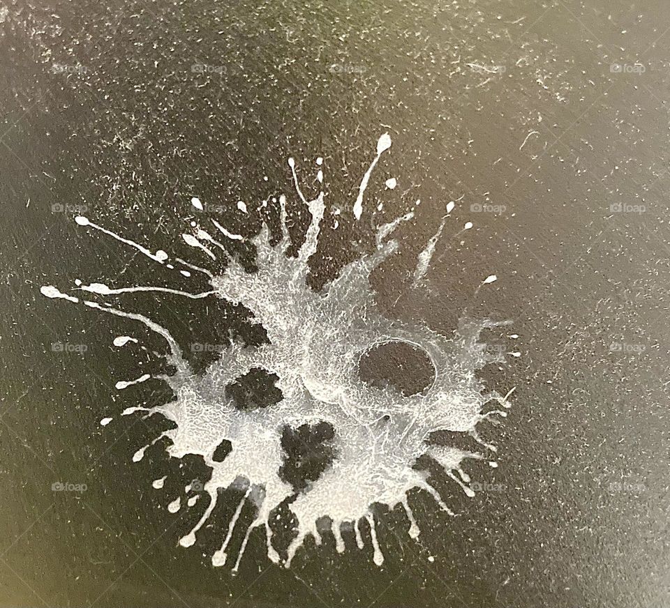 Of random paint splatter creates an unusual skull like image. Or perhaps an emerging face of some kind. 