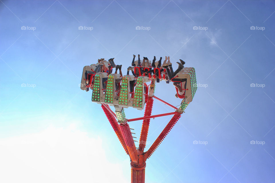 Amusement park or carnival ride, mid-flip upside down