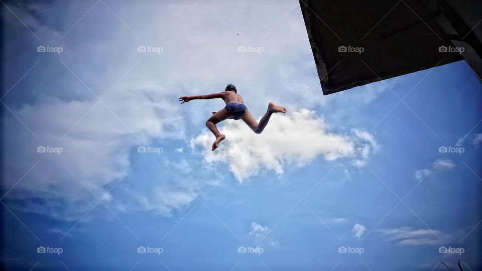 a child who jumped from a height that looked like he was jumping on a cloud