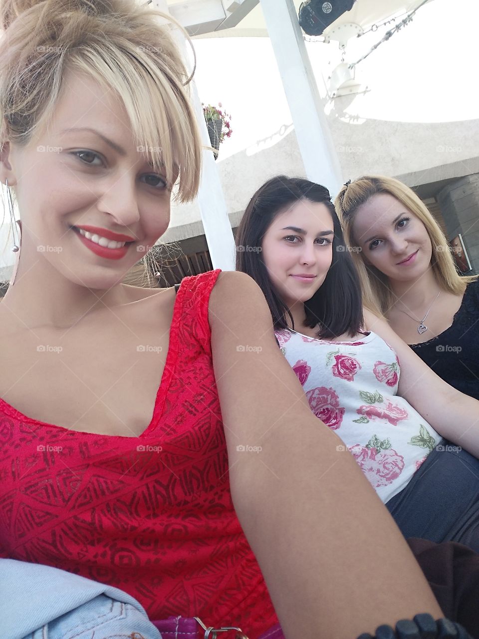 Young woman taking selfie with friends