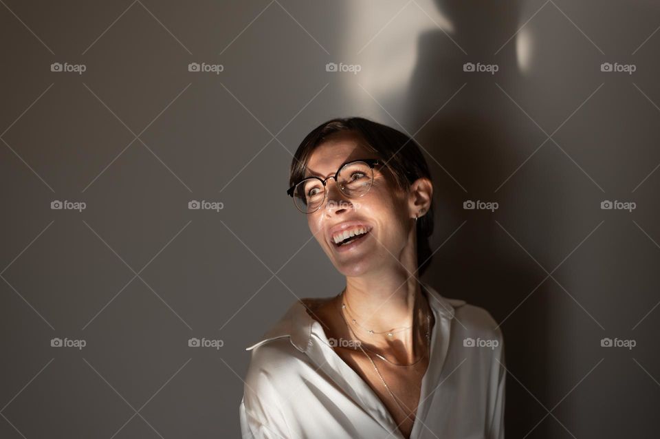 Cheerful young woman in white shirt