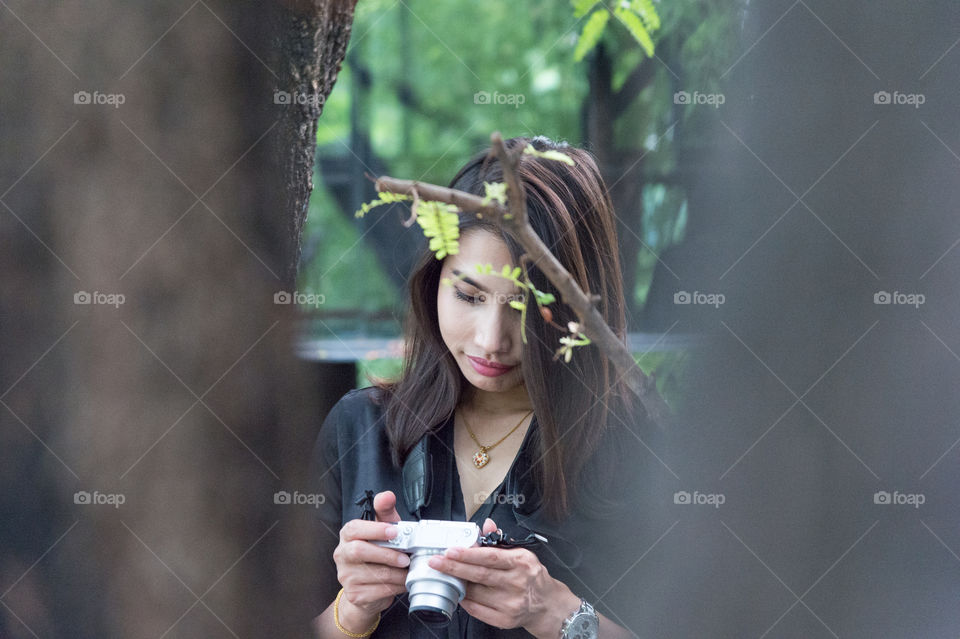 Woman holding digital camera in hand