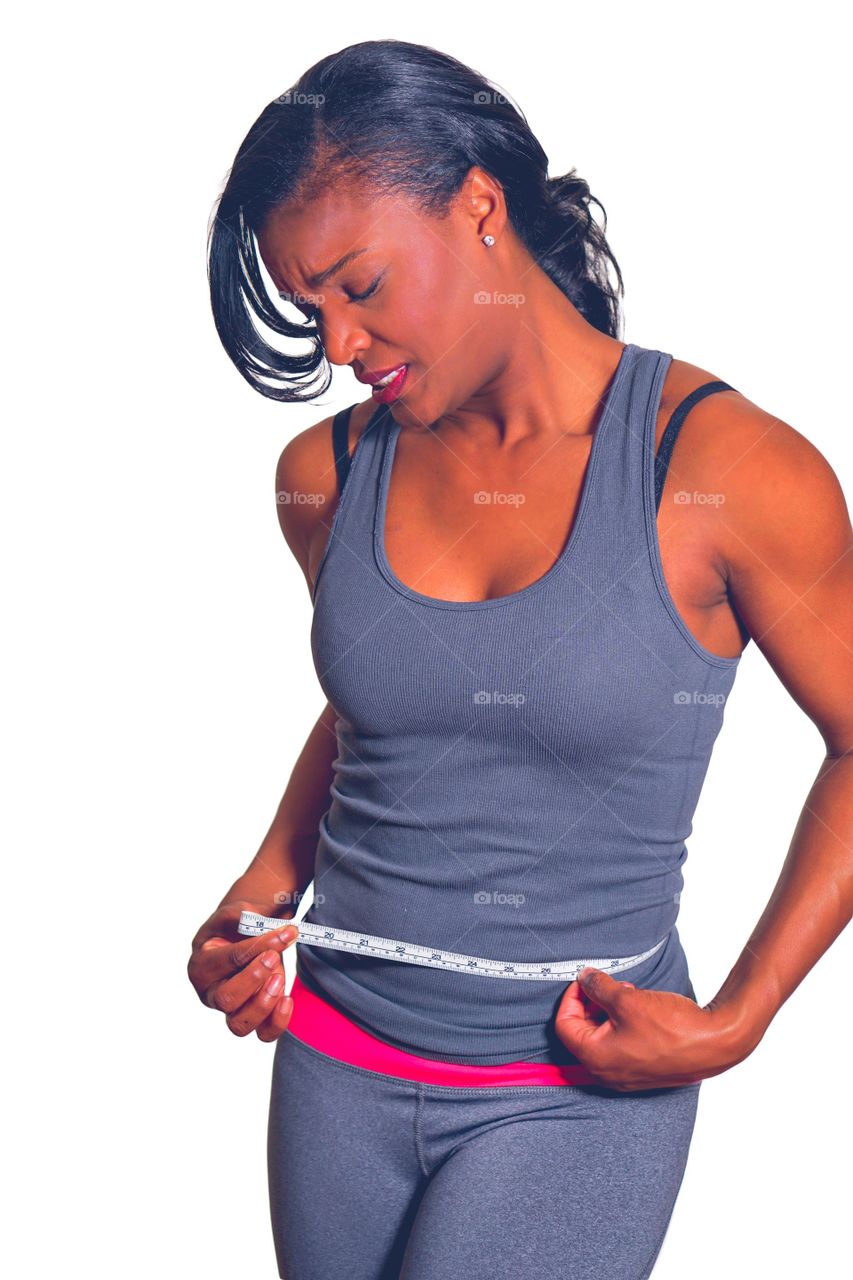 Woman measuring her waist with tape measure