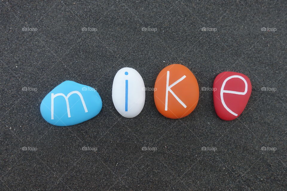 Mike, masculine given name composed with colored stones over black volcanic sand