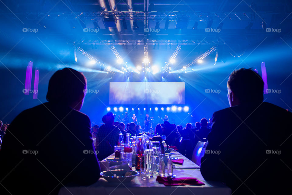 A large corporate event with live performers and various appearances in a large arena.