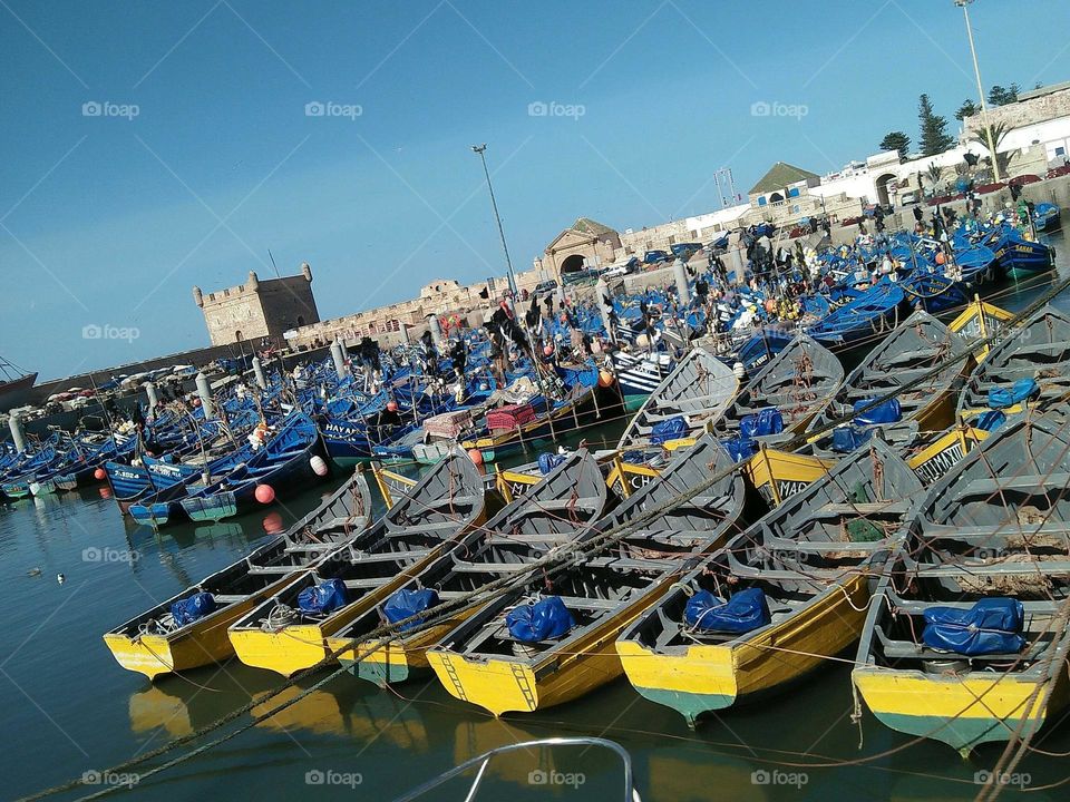 Flock of blue and yellow  boats  in the harbour at essaouira city.