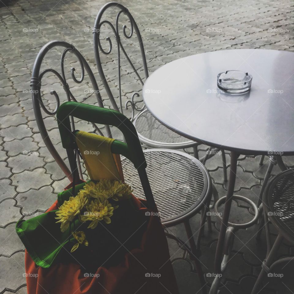 An old man asked me to take care of his bags while he went inside the coffee shop on a rainy day. To my surprise, the yellow flowers were the only colorful thing around, so I named this picture the coloured sheep.