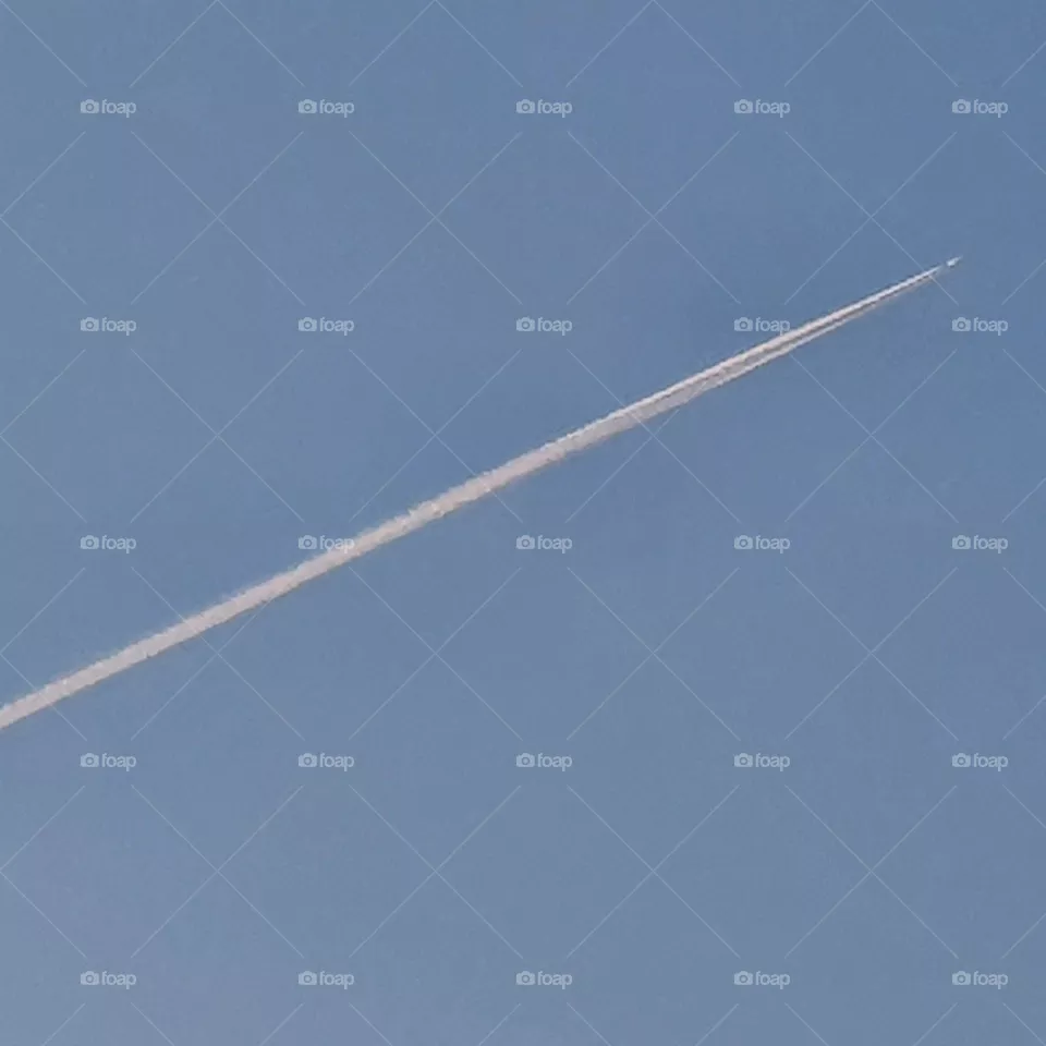 High in the sky a jet plane.
