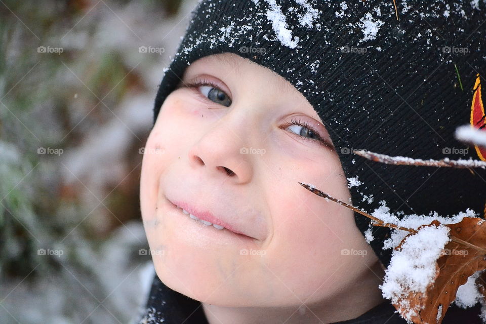 Cute happy boy in the snow