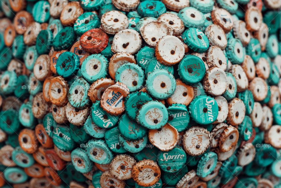 Full frame close-up photo of weathered rusty bottle caps