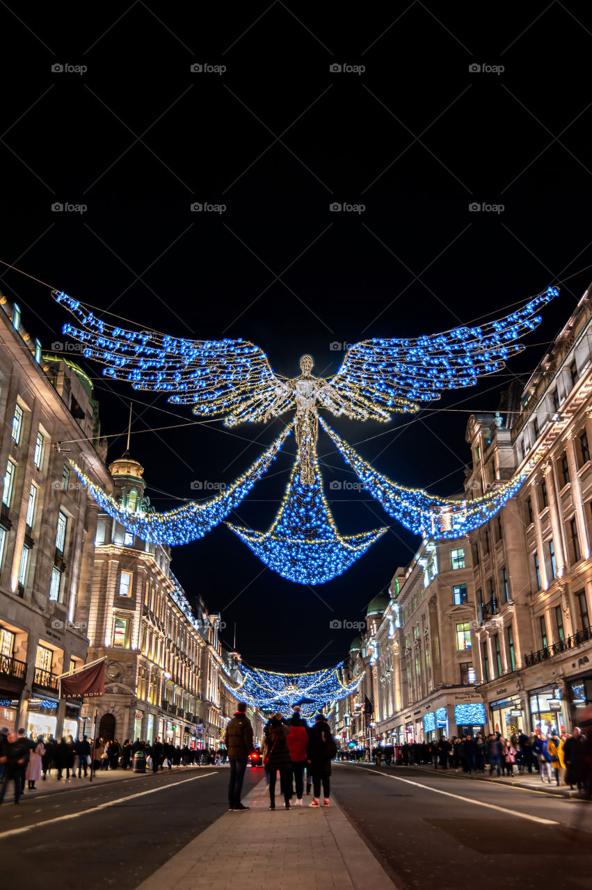 Walking and admiring beautiful Angel Christmas Decorations in Regent's Street and Oxford Street in landmark shopping district. December 2019. London. UK.