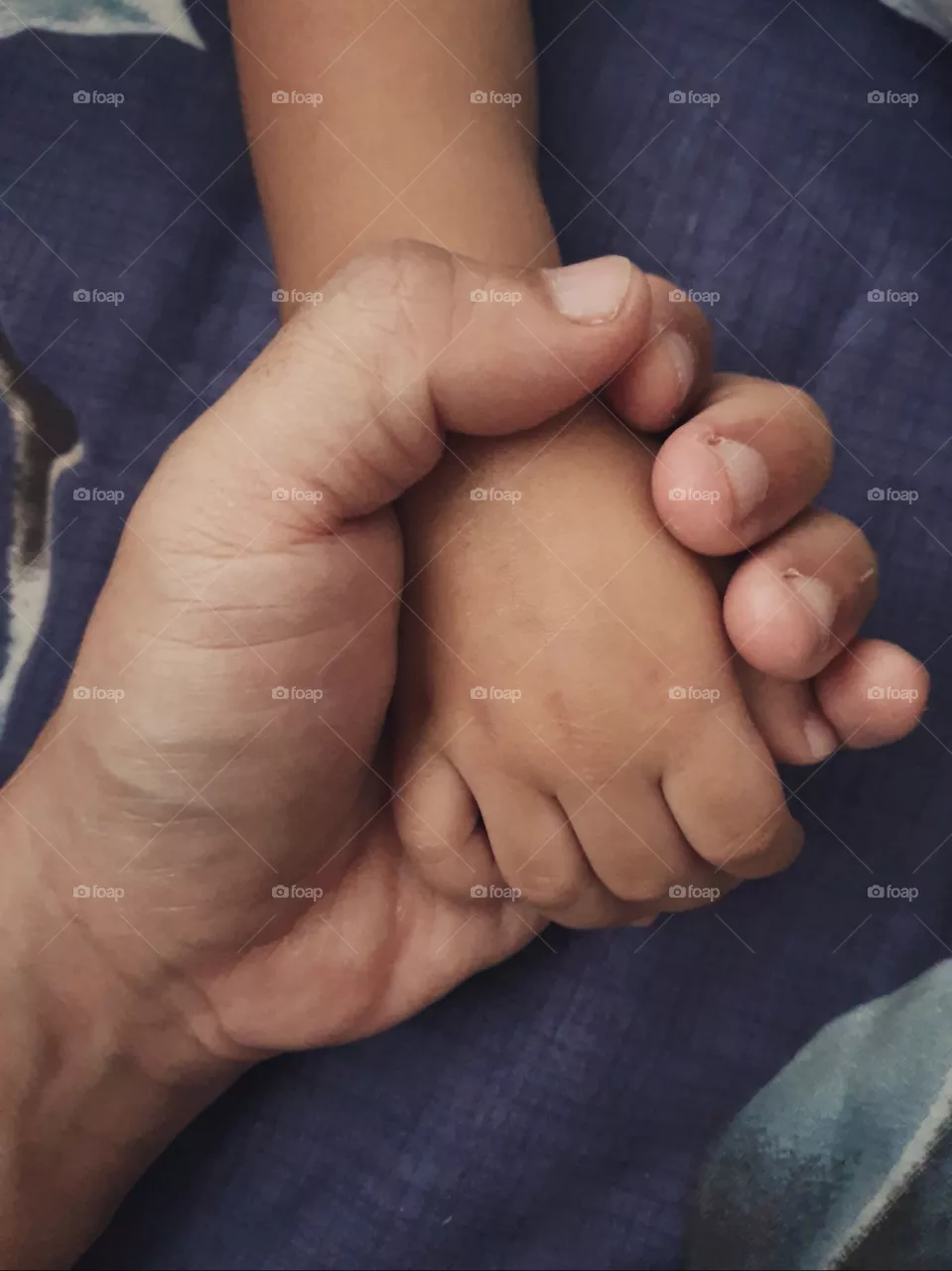 father and son holding hand