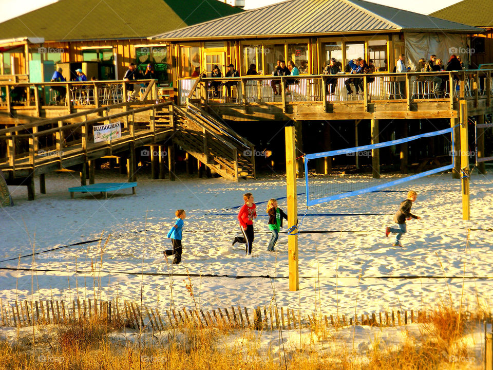 Afternoon . Children playing volleyball at dusk