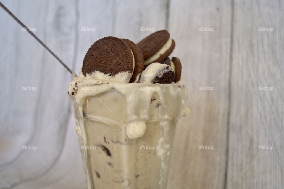 Oreo cookie milkshake with a wooden rustic white background
