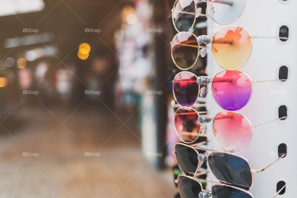 Colorful sunglasses Hung in a row in front of the store in the market