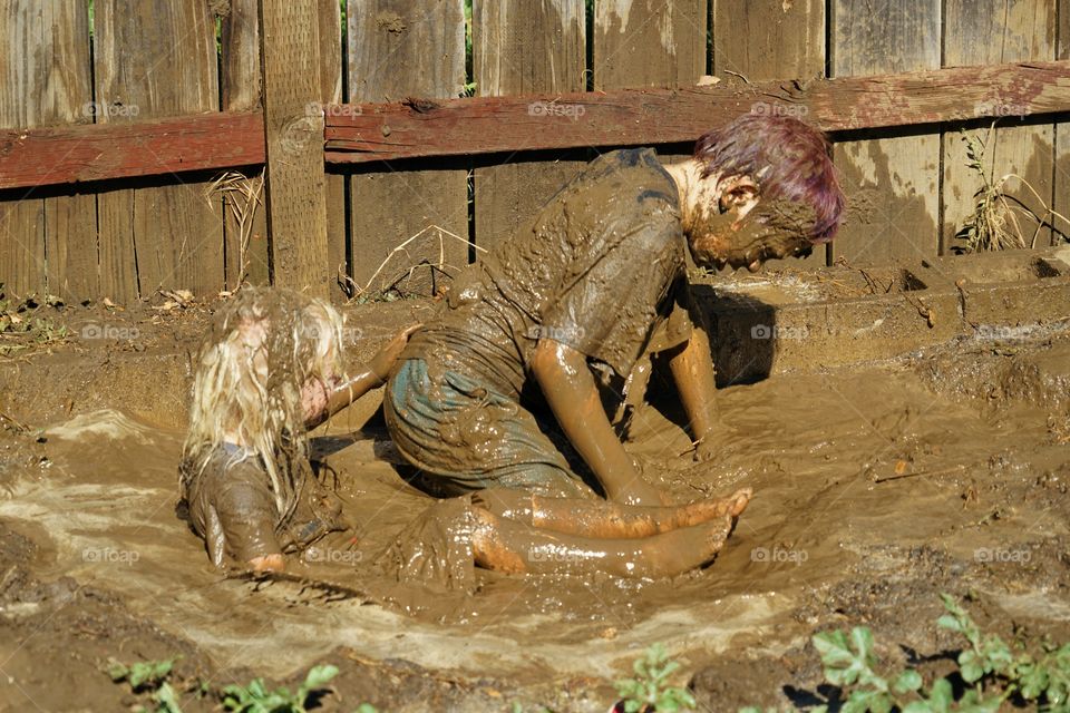 Kids Playing In Mud