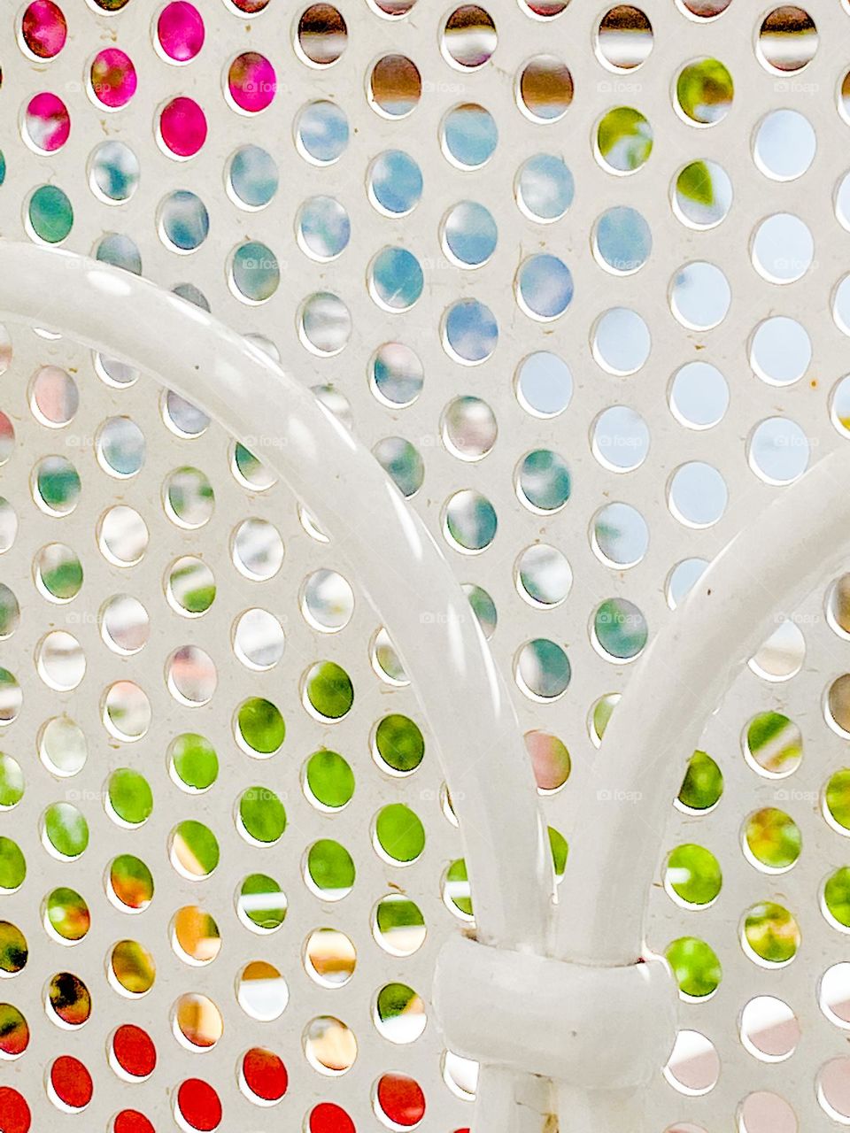 White garden fence with circular patterns