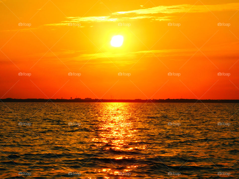 The sky was filled with the most brilliant orange complimented perfectly with hues of gold, yellow, red and crimson. An orange haze had casted over the water, reflecting off every wave.  Finally,the sun disappears along with the shine. I can only wait to see another magical moment of beauty and warmth! I can only wait for another sunset! Enjoy!