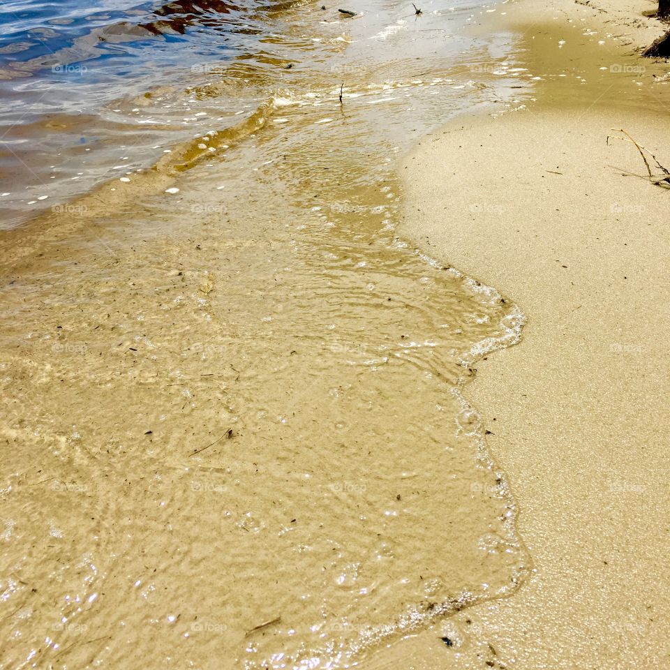 Water flowing on sand 