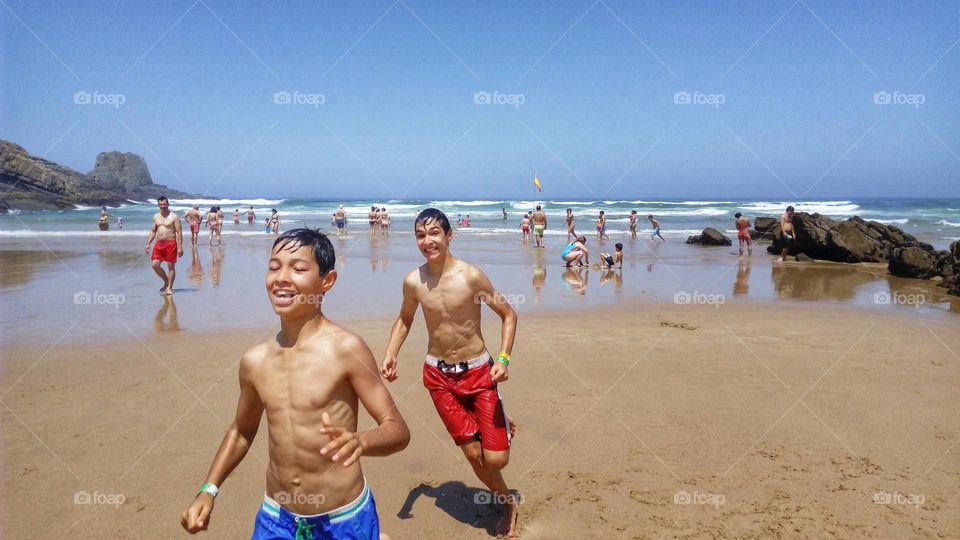 Boys running on the beach, Algarve, Portugal