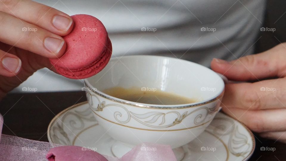 A woman eating macaroon