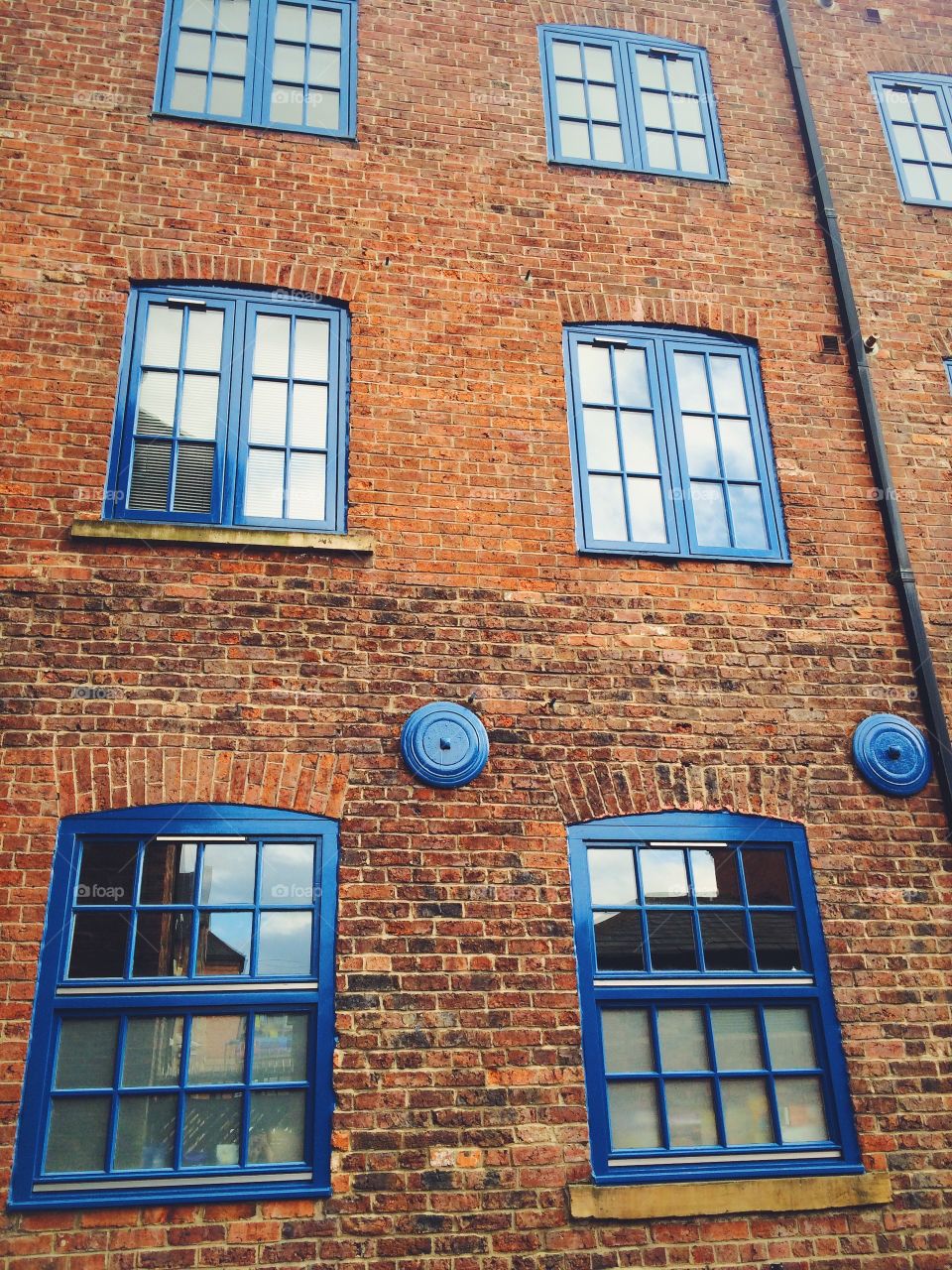 Old brick building featuring cobalt blue trim in Leeds England 
