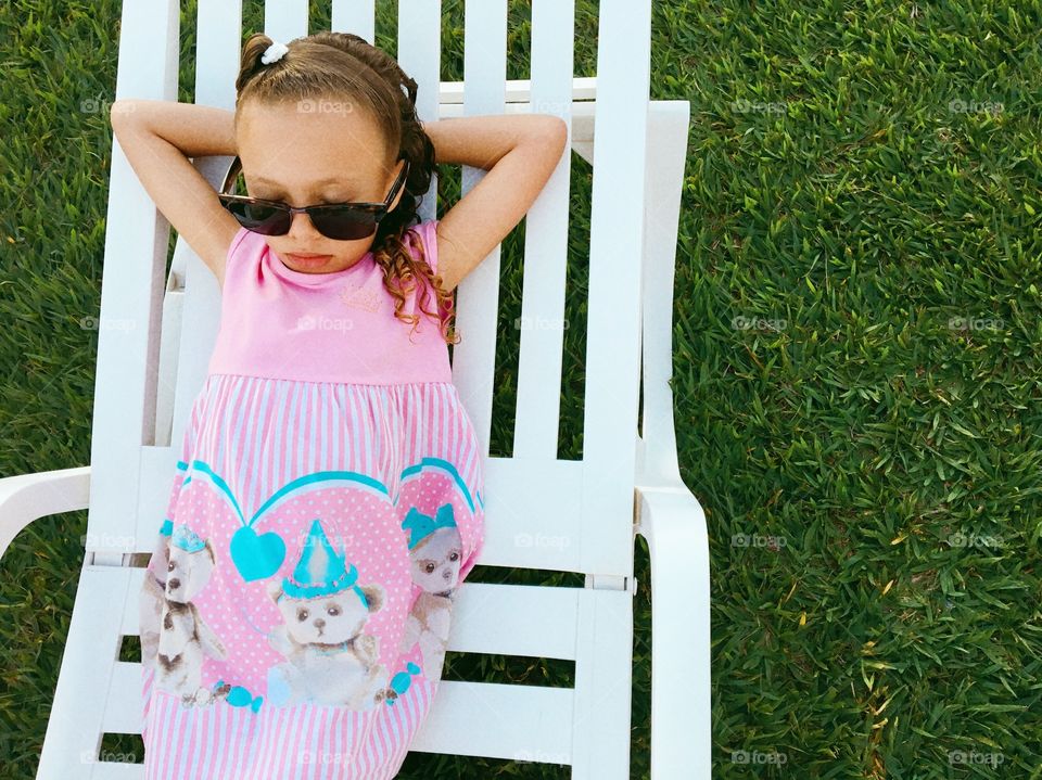 Little girl resting in the garden