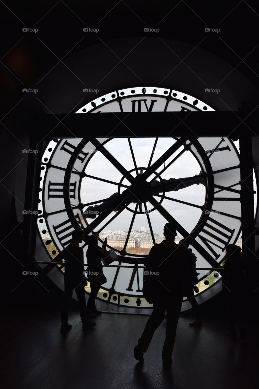 People look out of a clock at the Museum d'Orsay in Paris, France. October 2016.