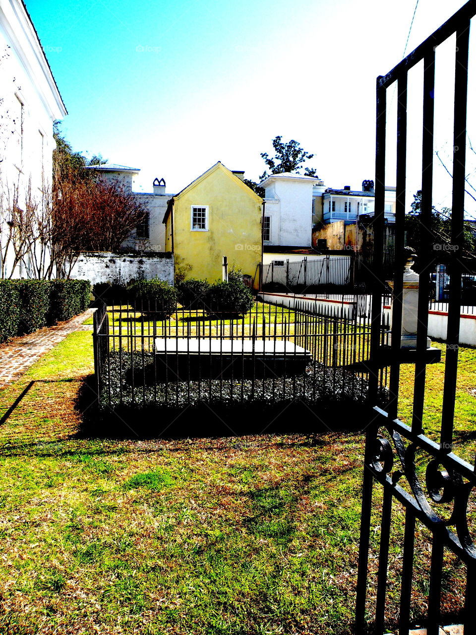 Charleston historic Cemetery in mansion yard with open gate. Charleston historic Cemetery in mansion yard with open gate