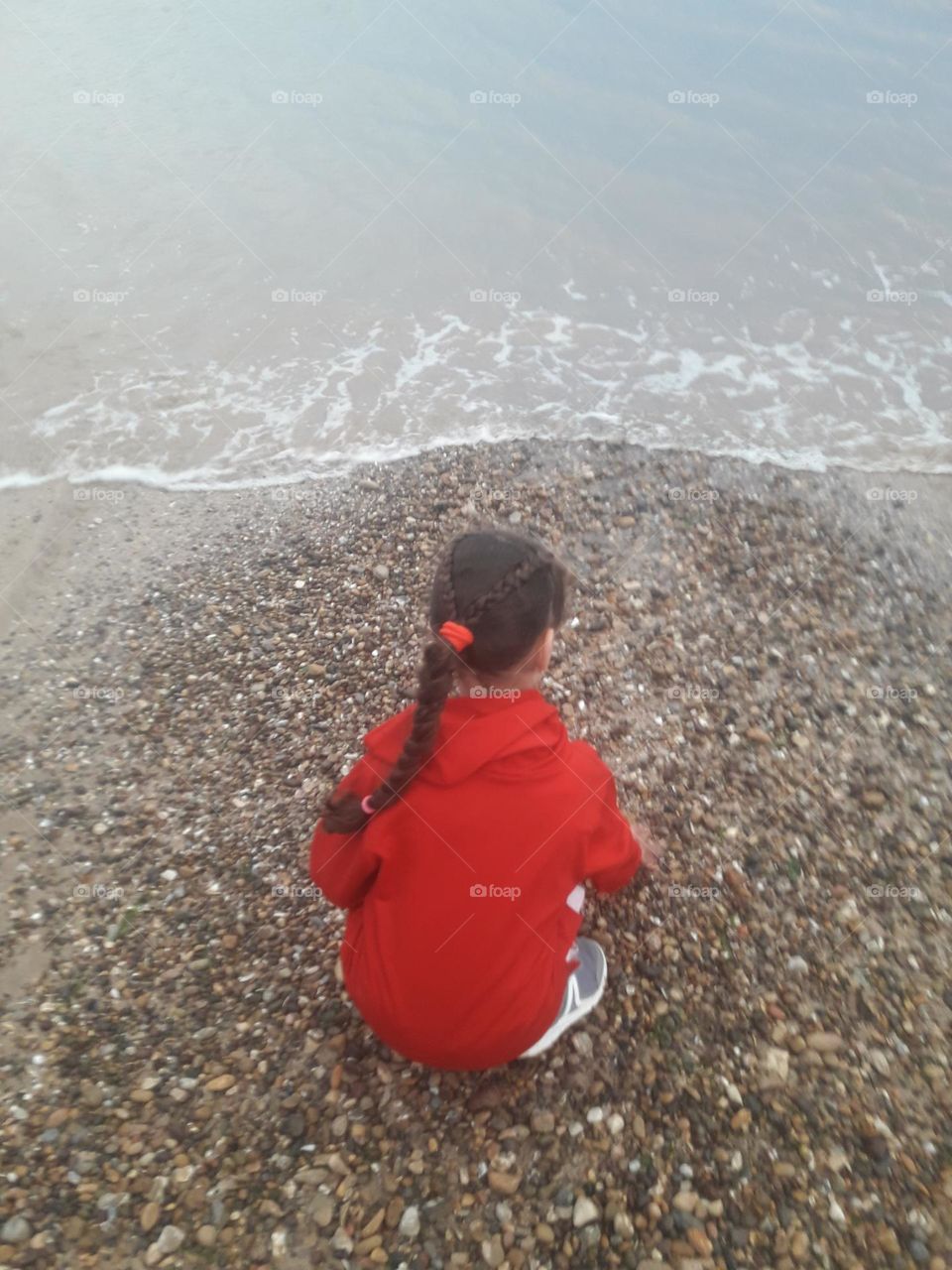 Young girl plays near the beach