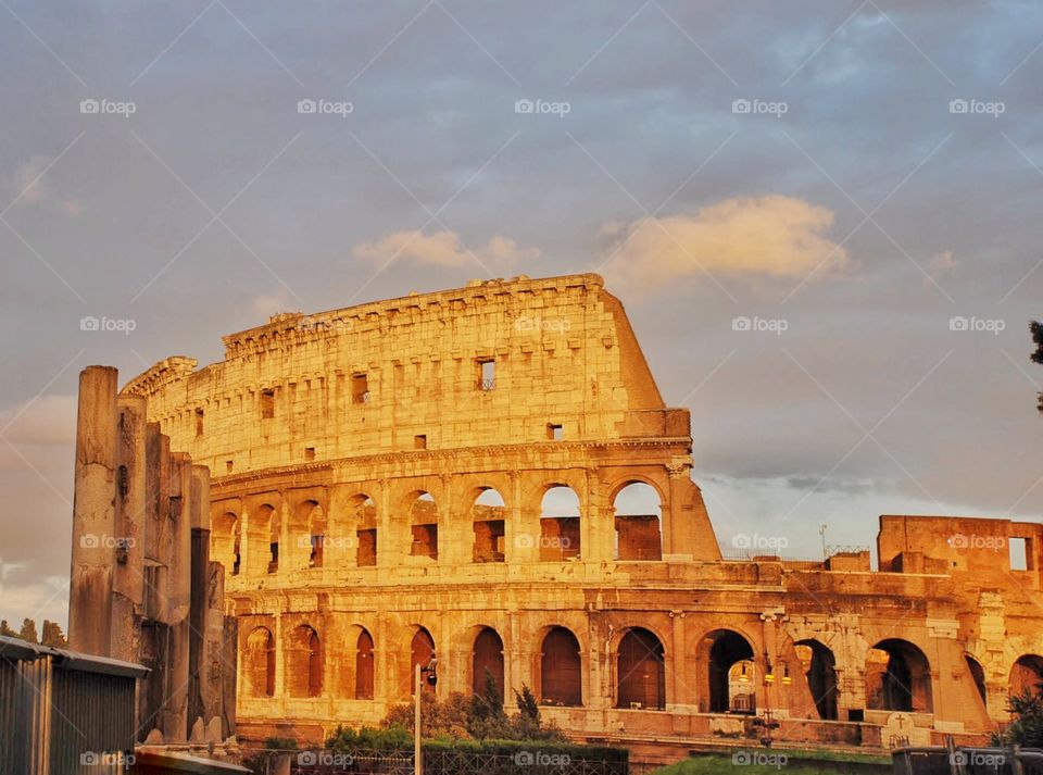 Roman Colosseum. The Roman Colosseum at sunset with pink clouds