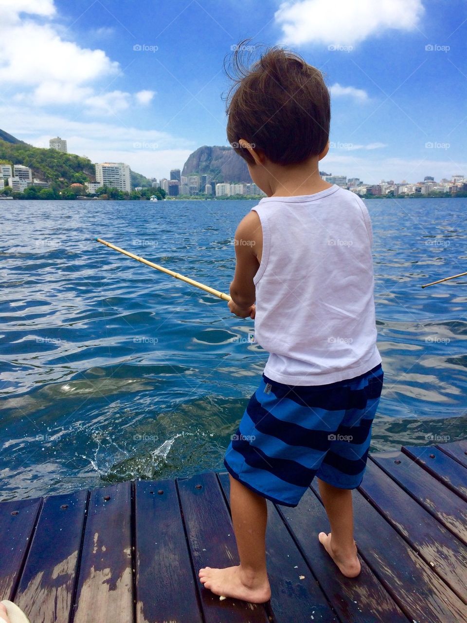 A small boy fishing in sea